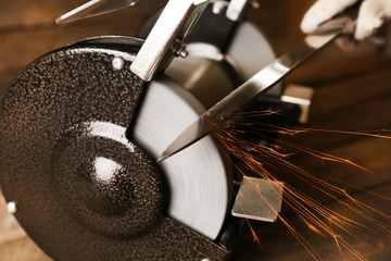 Knife sharpener on wooden table, closeup