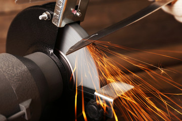 Knife sharpener on wooden table, closeup