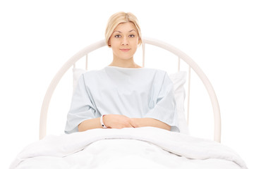 Beautiful young female patient lying in a hospital bed