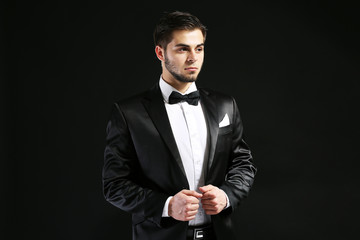 Elegant man in suit on dark background