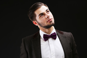 Elegant man in suit on dark background