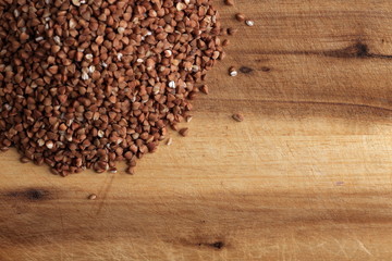 Grains of buckwheat on the kitchen board