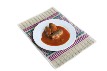 Tinned fish on tatami mat on white background