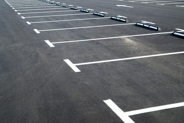 Markings on asphalt pavement indicating parking spaces