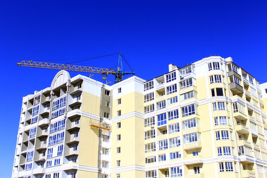construction of multistorey modern house with hoisting crane