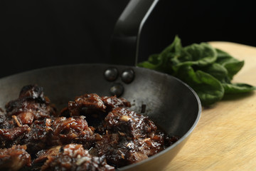 Pork ribs with honey-soy sauce in the frying pan