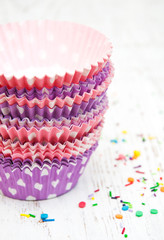 empty cupcake cups and color sprinkles