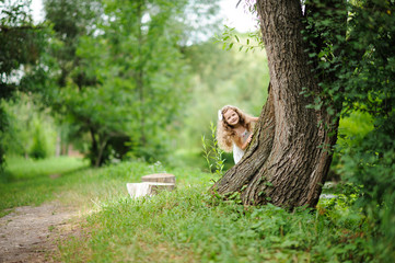 Little pretty girl in the green garden