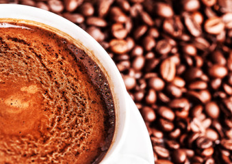 Coffee cup with roasted coffee beans may use as background