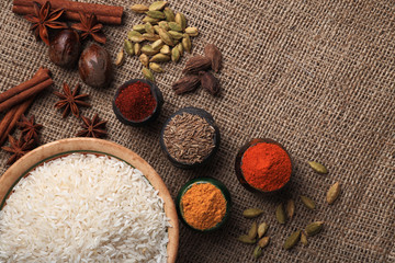 Rice and spices. Burlap background