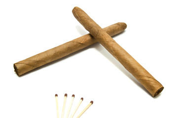 two Cuban cigars and matches on white