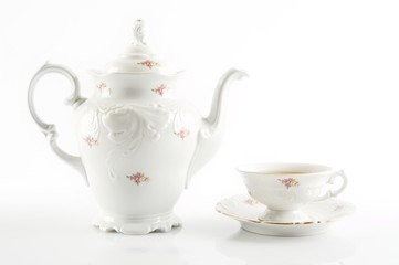 Old-style retro jug with tea on white background