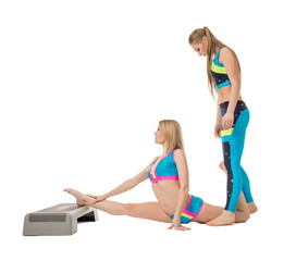 Pretty female gymnasts warming up in studio