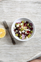 Homemade salad with beet, grapes and onions