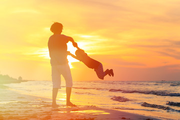 father and little son play at sunset