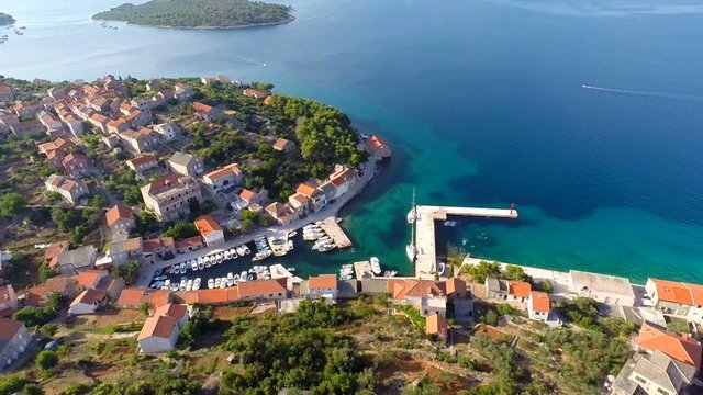 Aerial footage of village and harbour near sea