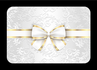 White card with ornament and white ribbon