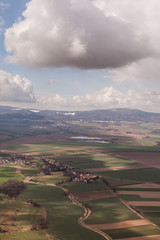 Naklejka premium aerial view of spring time village harvest fields landscape