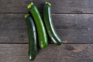 fresh courgettes on wooden table