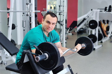 Fototapeta na wymiar Exercises for the biceps barbell