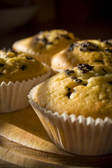 Sweet muffins on a wooden board in daylight