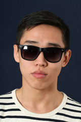 Romantic young Asian man in sunglasses