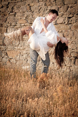 Good looking couple flirting outdoors against old ruin building