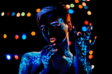 Girl with neon paint bodyart portrait, studio shot