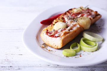 Tasty sandwich with bacon and cheese