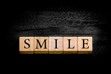 Word SMILE isolated on black background with copy space
