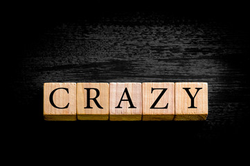 Word CRAZY isolated on black background with copy space