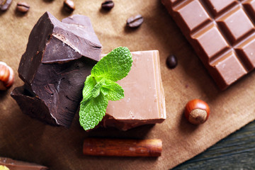 Delicious chocolates with spices on table, closeup