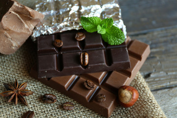 Delicious chocolate with spices on wooden table, closeup