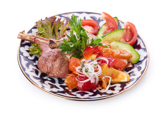 Meat on a grill with vegetables