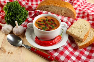 Bean soup in bowl with fresh sliced bread