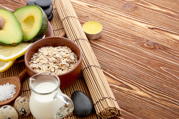 Fresh avocado on cutting board over wooden background