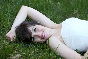 Smiling woman relaxing on the lawn
