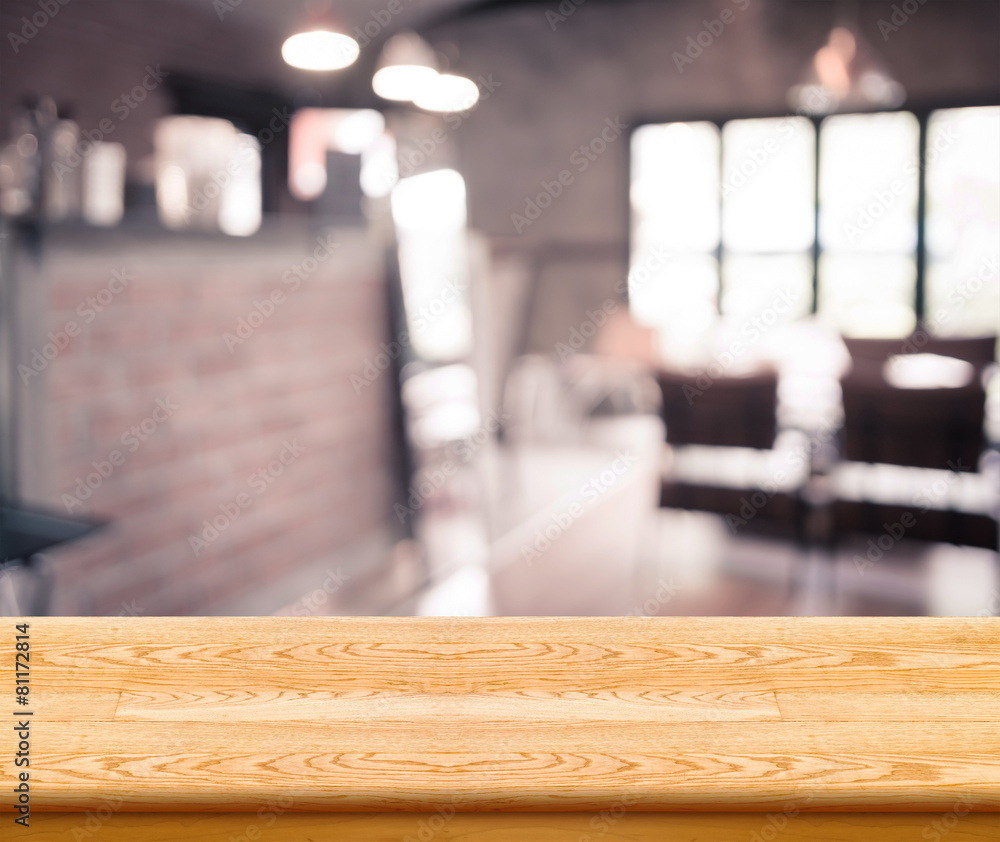 Poster Empty wood table top with coffee shop blur with bokeh background
