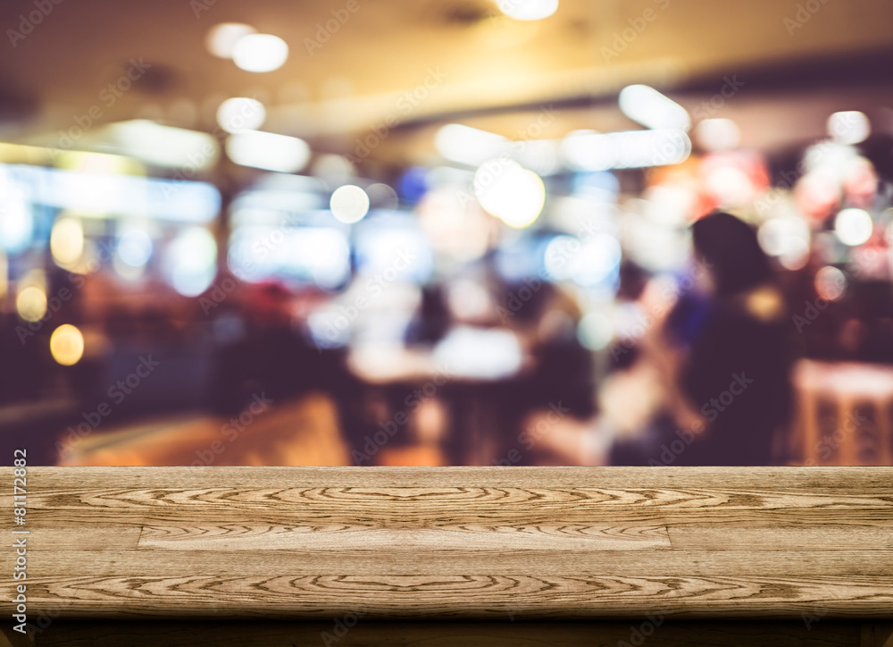 Poster empty wood table top with coffee shop blur with bokeh background