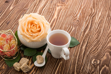 Tea cups with teapot on old wooden table