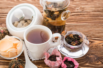 Tea cups with teapot on old wooden table