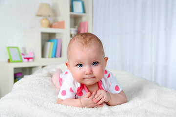 Cute baby girl, on home interior background