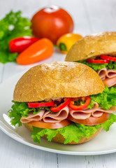 Healthy ham sandwiches with vegetables on background