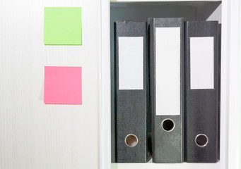Folders for documents on a book shelf