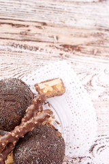 Cupcake with chocolate on wooden background