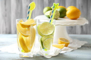 Cocktails with fresh citrus fruits on wooden background