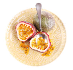 Passion fruit on plate isolated on white