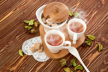 tea with sugar cubes on wooden