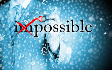 Businessman Hand turning the word Impossible into Possible with