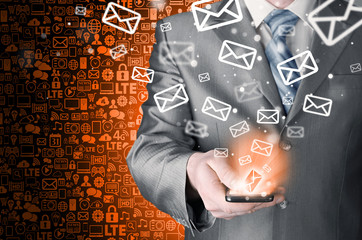 Business man holding smart phone and sending emails